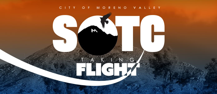 Moreno Valley Economic Development logo featuring a mountain and a soaring bird with the slogan 'Taking Flight' against a sunset background.